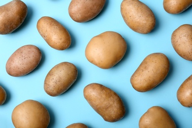 Photo of Flat lay composition with fresh organic potatoes on color background