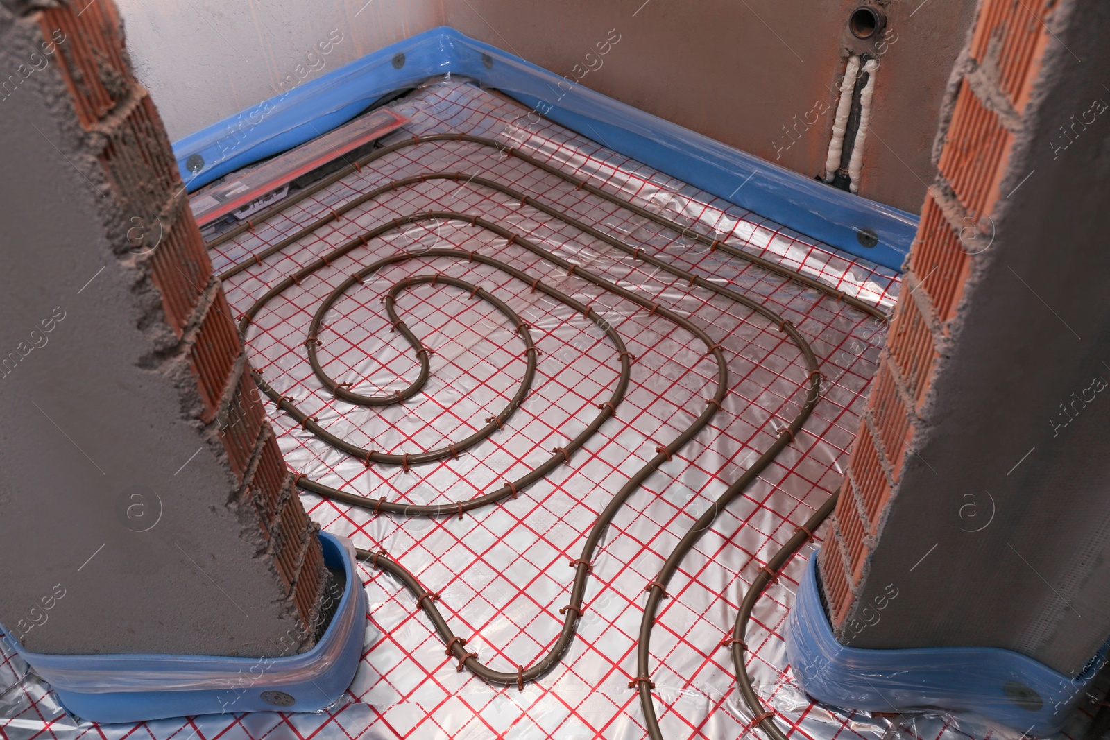 Photo of Installation of underfloor heating system in building