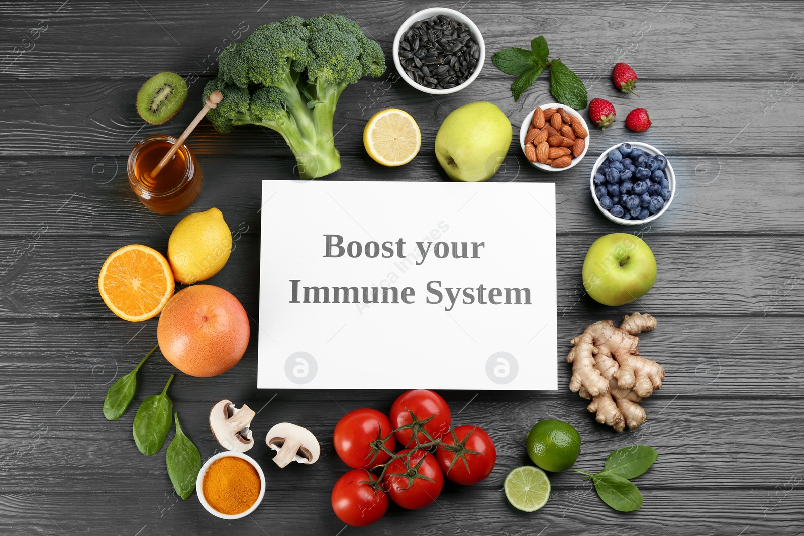Photo of Card with phrase Boost Your Immune System and fresh products on grey wooden table, flat lay