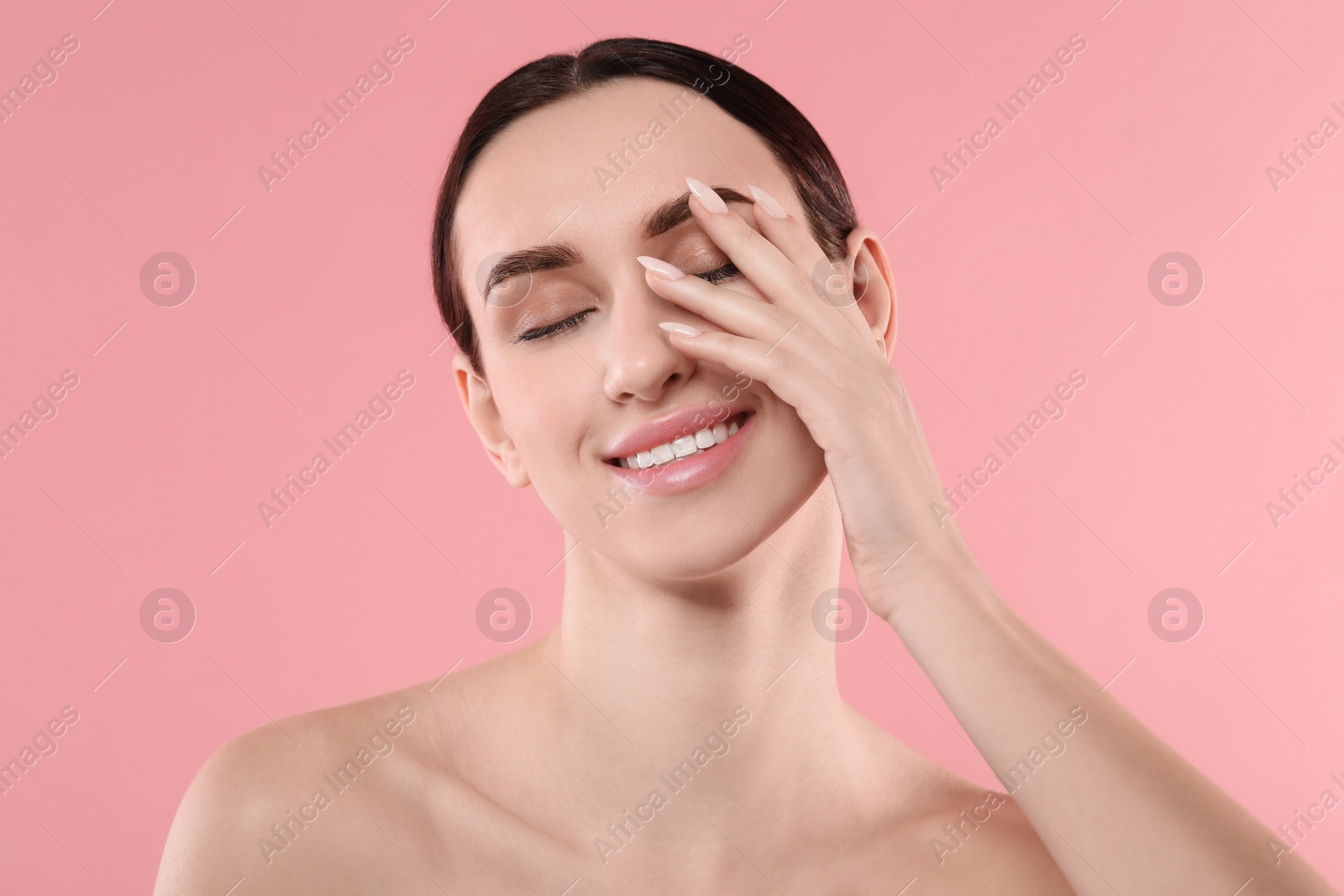 Photo of Portrait of beautiful young woman on pink background