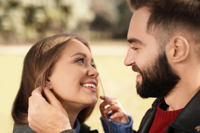 Photo of Portrait of cute young couple outdoors, closeup