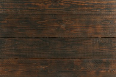 Photo of Texture of dark wooden surface as background, closeup