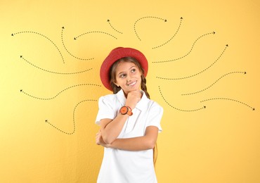 Image of Choice in profession or other areas of life, concept. Making decision, cute preteen girl surrounded by drawn arrows on yellow background