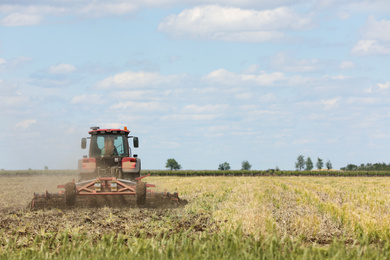 Photo of Modern agricultural machinery in field on sunny day