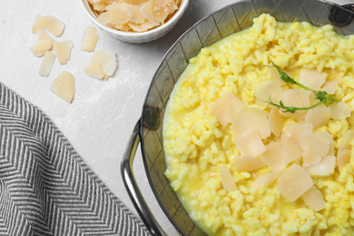 Delicious risotto with cheese on grey marble table, flat lay