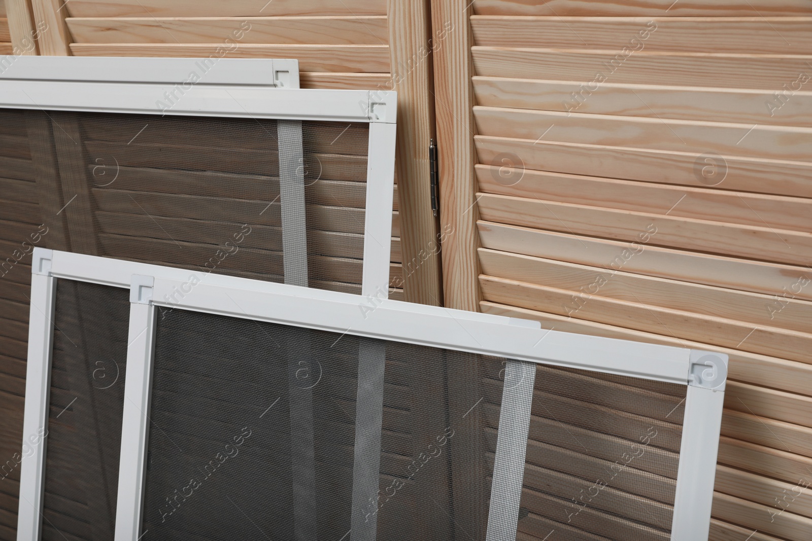 Photo of Set of window screens near wooden folding screen