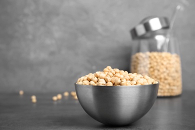 Photo of Metal bowl with dried peas on table