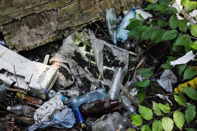 Photo of Pile of different garbage on ground outdoors, above view