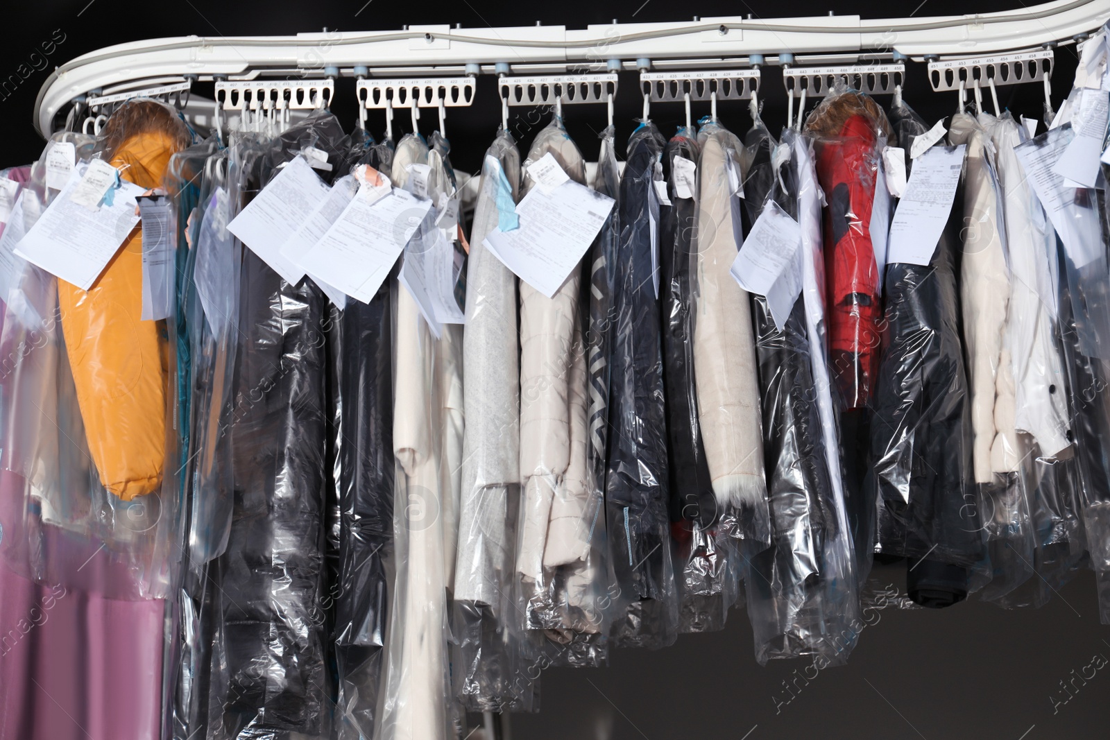 Photo of Hangers with clothes on garment conveyor at dry-cleaner's