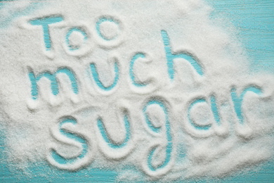 Photo of Flat lay composition with phrase TOO MUCH SUGAR on blue wooden table