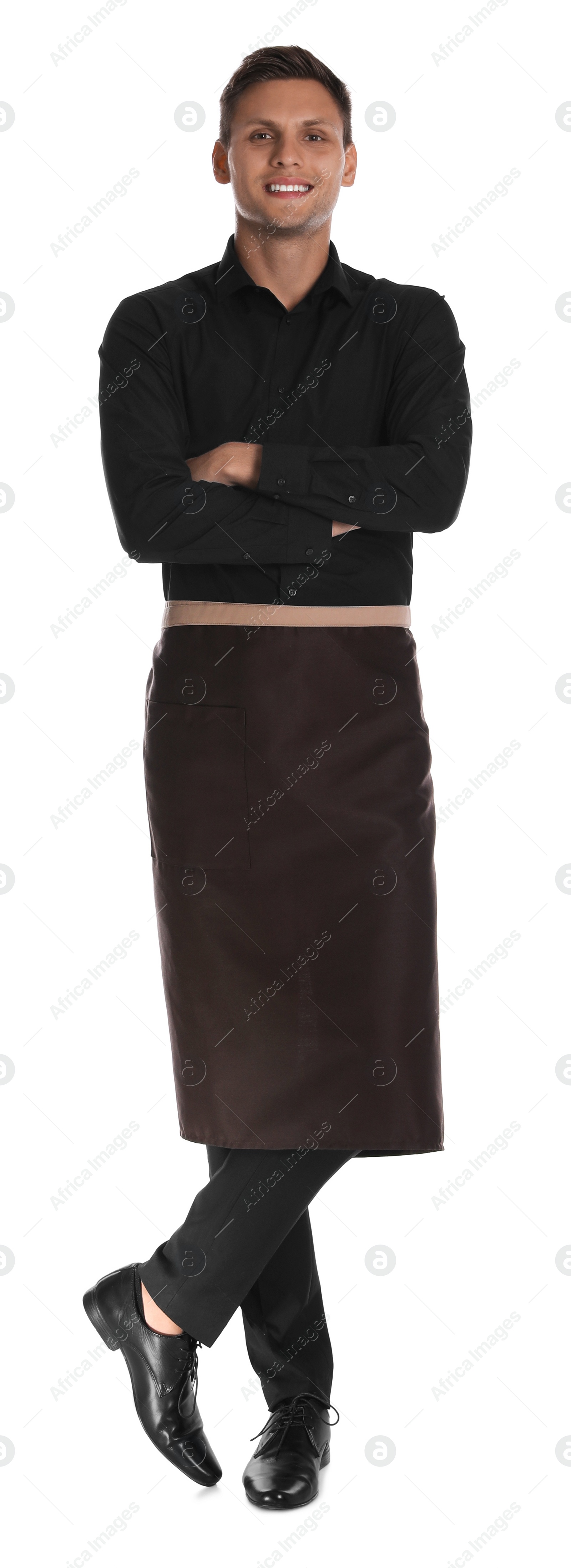 Photo of Full length portrait of happy young waiter in uniform on white background