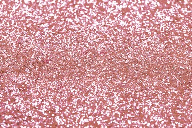 Beautiful pink shiny glitter as background, closeup