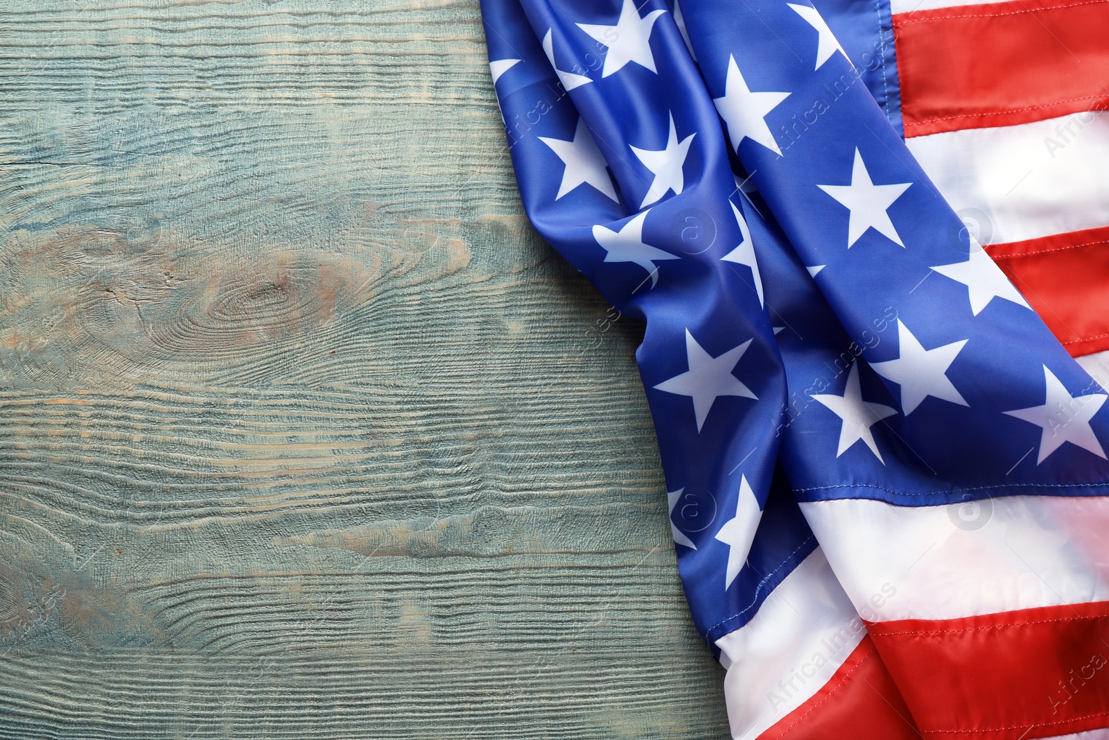 Photo of American flag on wooden background, space for text