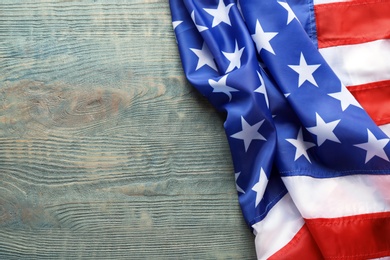 Photo of American flag on wooden background, space for text