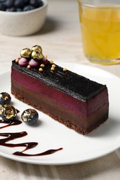 Delicious cake with blueberry on white wooden table