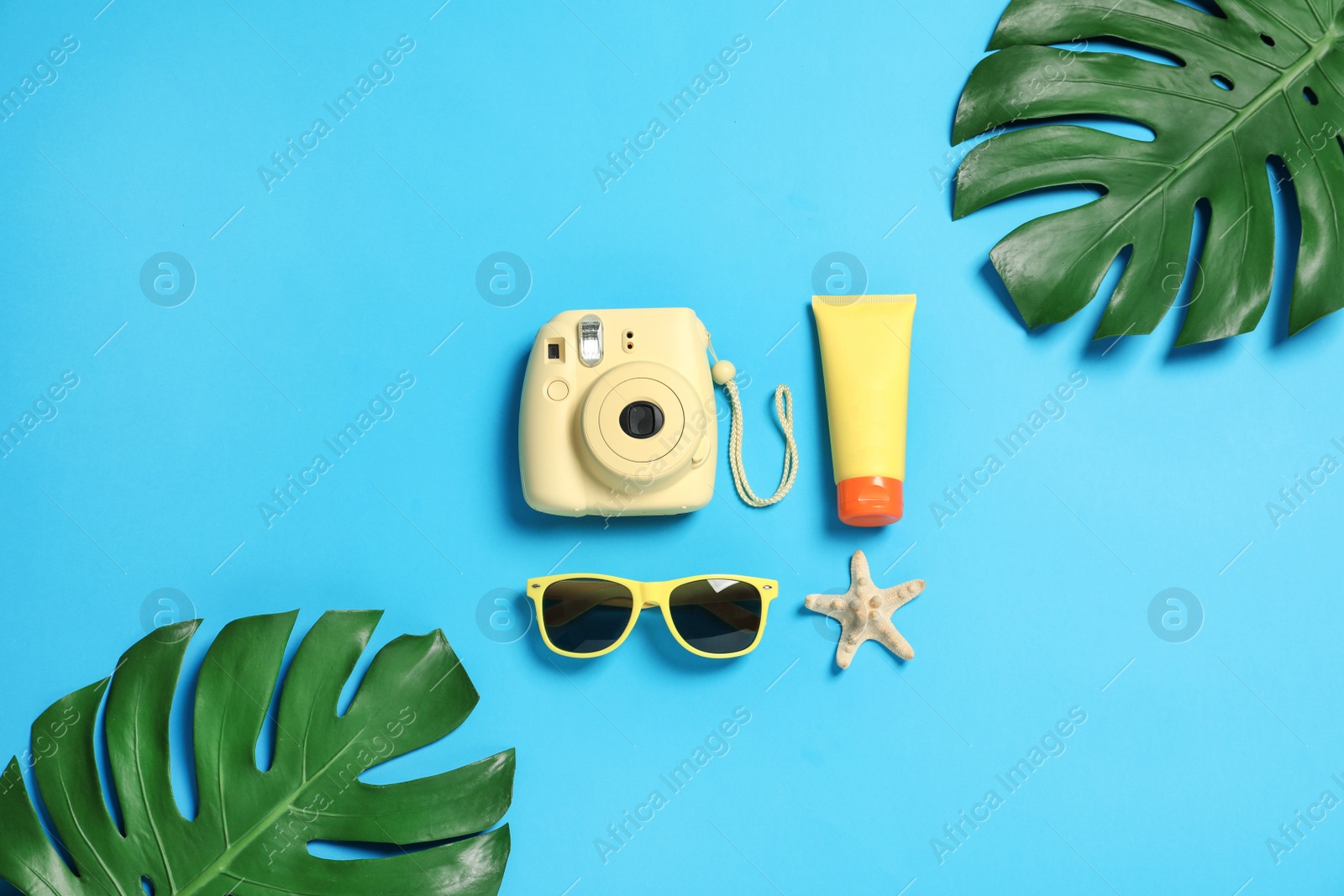 Photo of Flat lay composition with beach accessories on color background