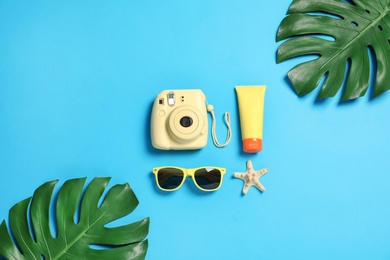 Flat lay composition with beach accessories on color background