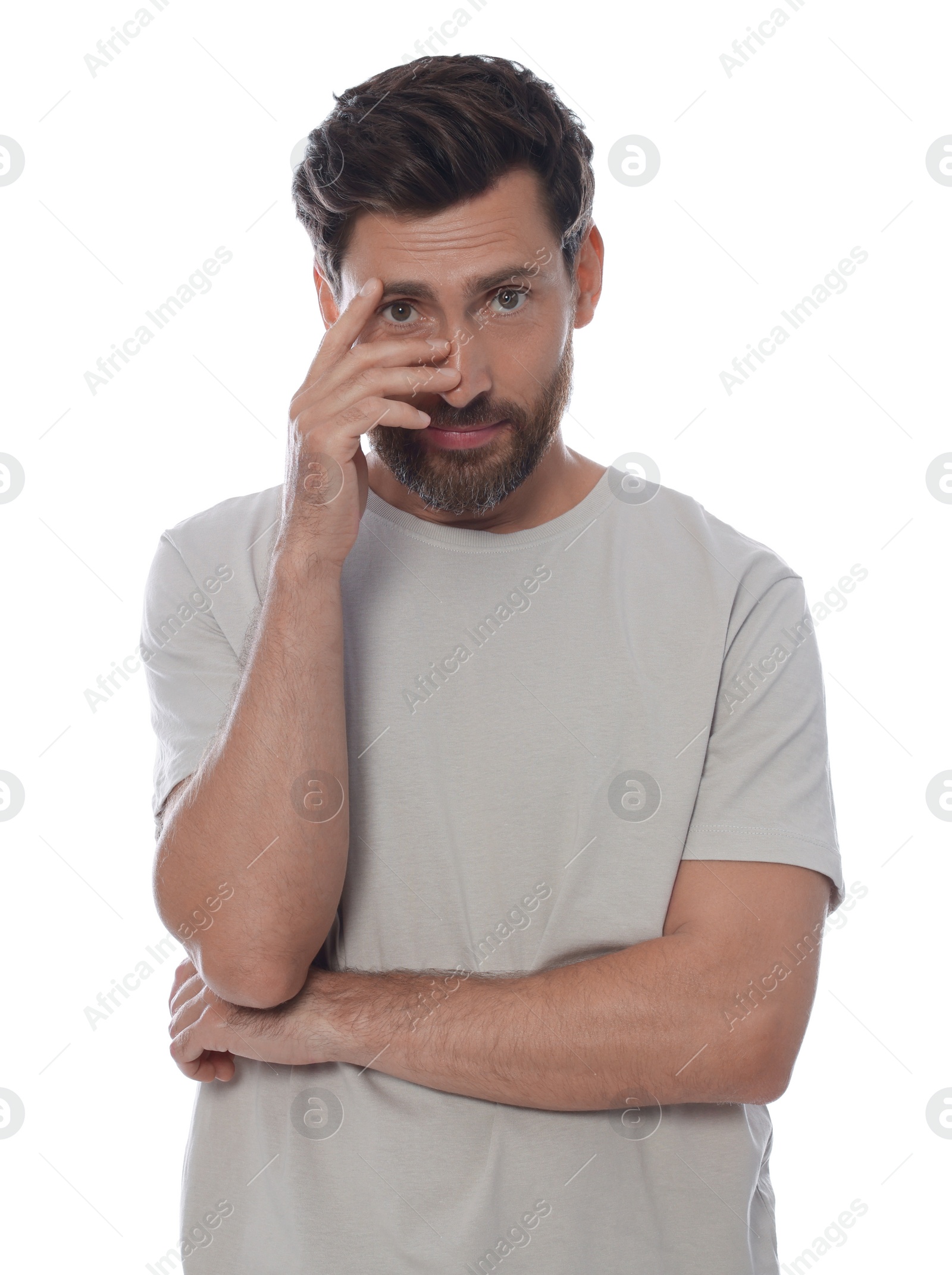 Photo of Embarrassed man covering face with hand on white background