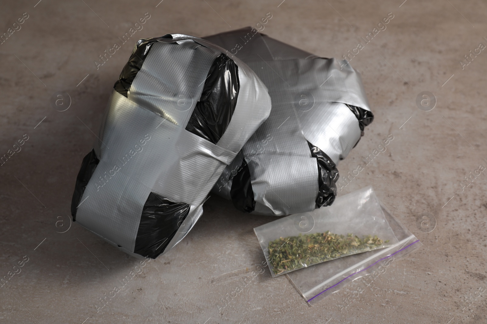 Photo of Packages with narcotics on grey textured table