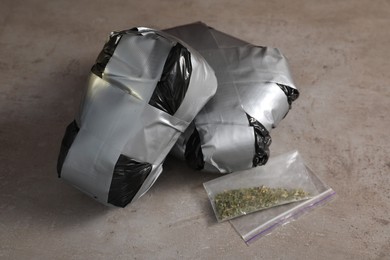 Packages with narcotics on grey textured table