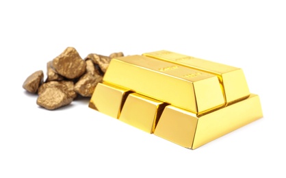 Photo of Gold nuggets and ingots on white background