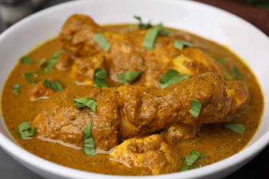 Photo of Delicious chicken with curry sauce in bowl, closeup