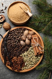 Photo of Different spices, nuts and fir branches on table, flat lay