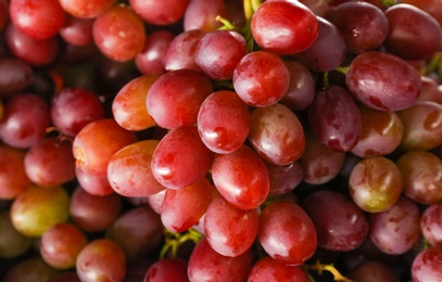 Photo of Fresh ripe juicy red grapes as background, closeup view