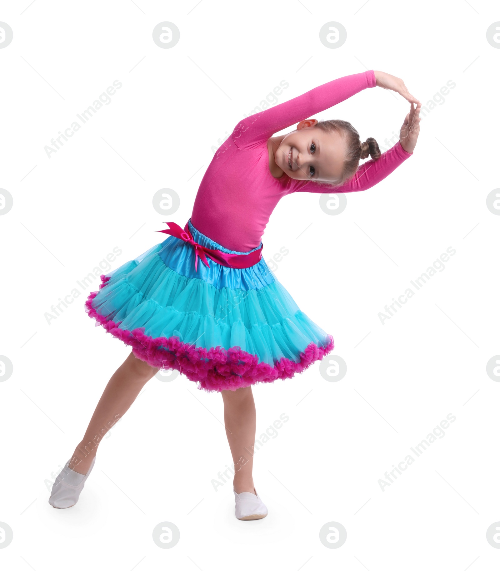 Photo of Cute little girl in costume dancing on white background