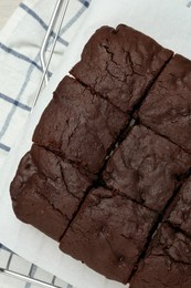 Delicious freshly baked brownies on table, top view