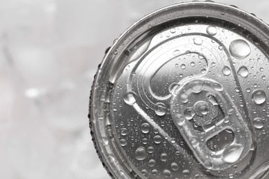 Energy drink in wet can on light background, top view. Space for text