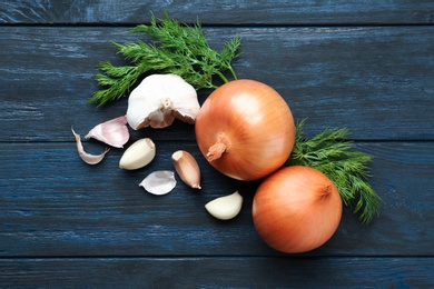 Photo of Flat lay composition with garlic, onions and dill on wooden background