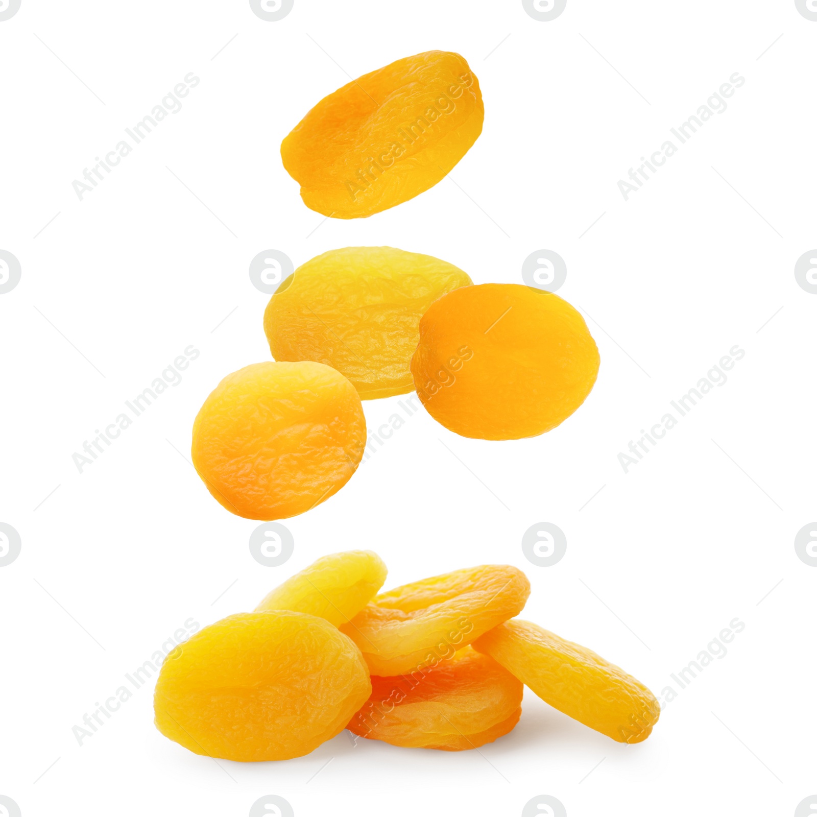 Image of Tasty dried apricots falling on white background