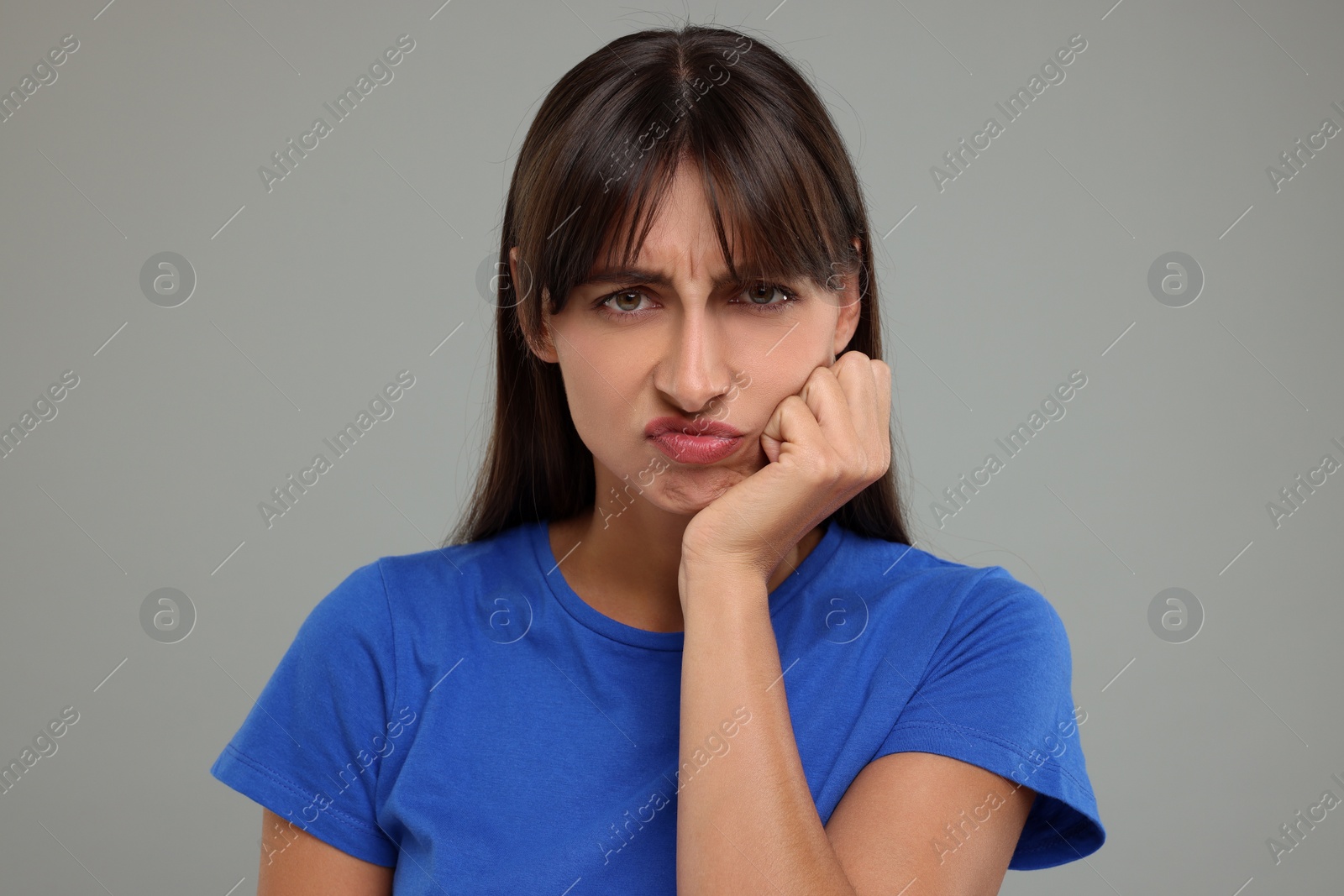 Photo of Portrait of resentful woman on light grey background