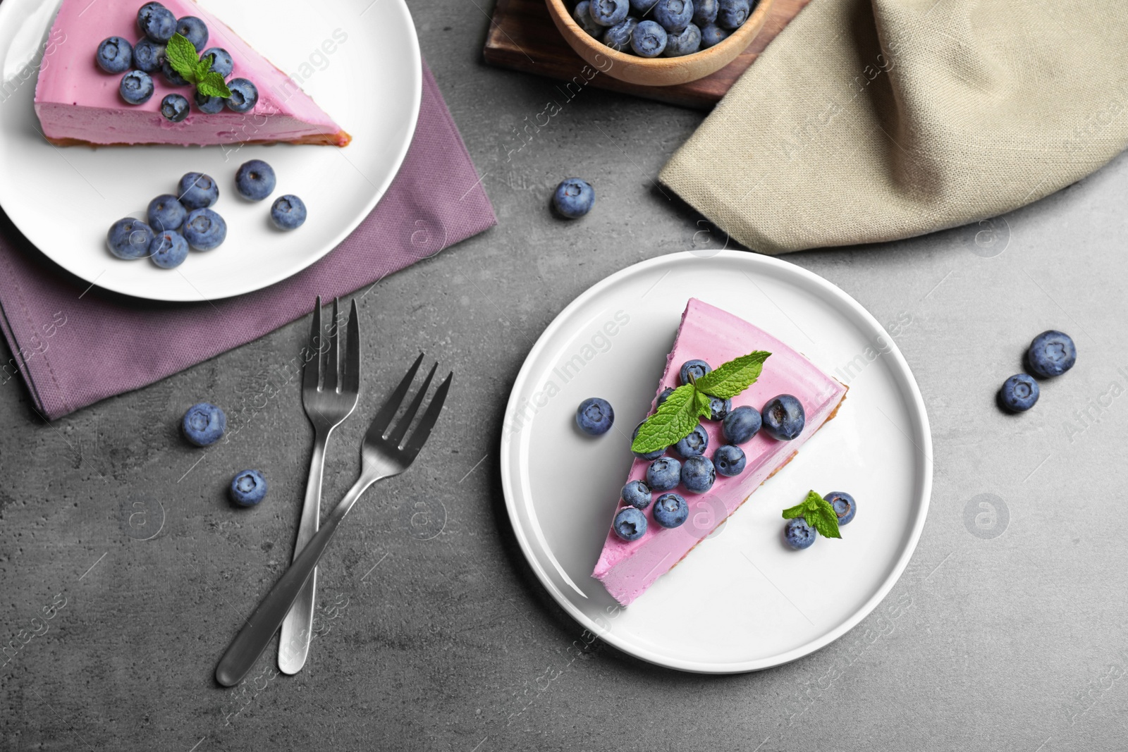 Photo of Flat lay composition of tasty blueberry cake on grey table