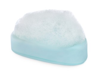 Photo of Soap bar with fluffy foam on white background