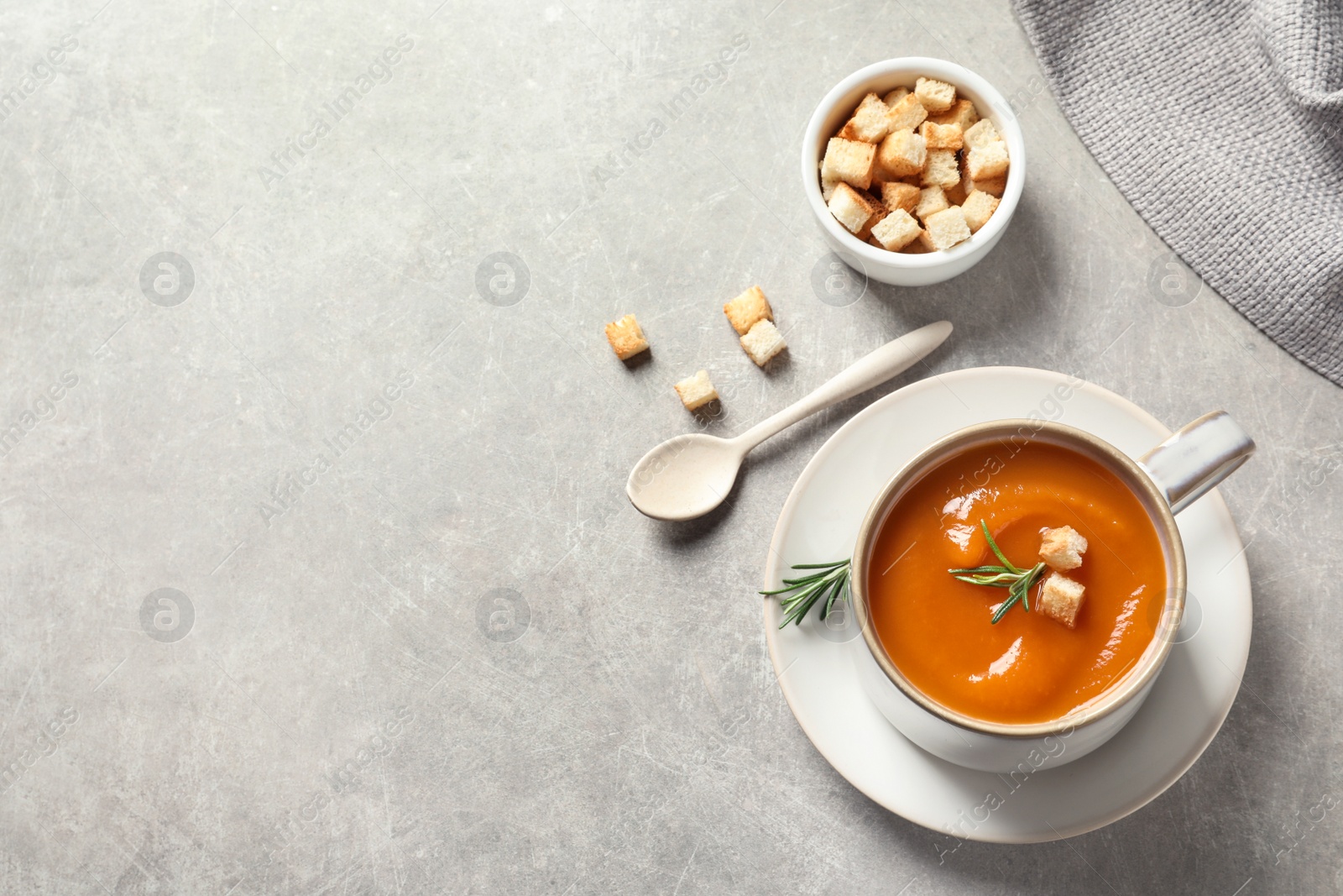 Photo of Flat lay composition with mug of tasty sweet potato soup and space for text on grey background