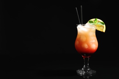 Photo of Just made appetizing cocktail Sex on the Beach, black background. Space for text