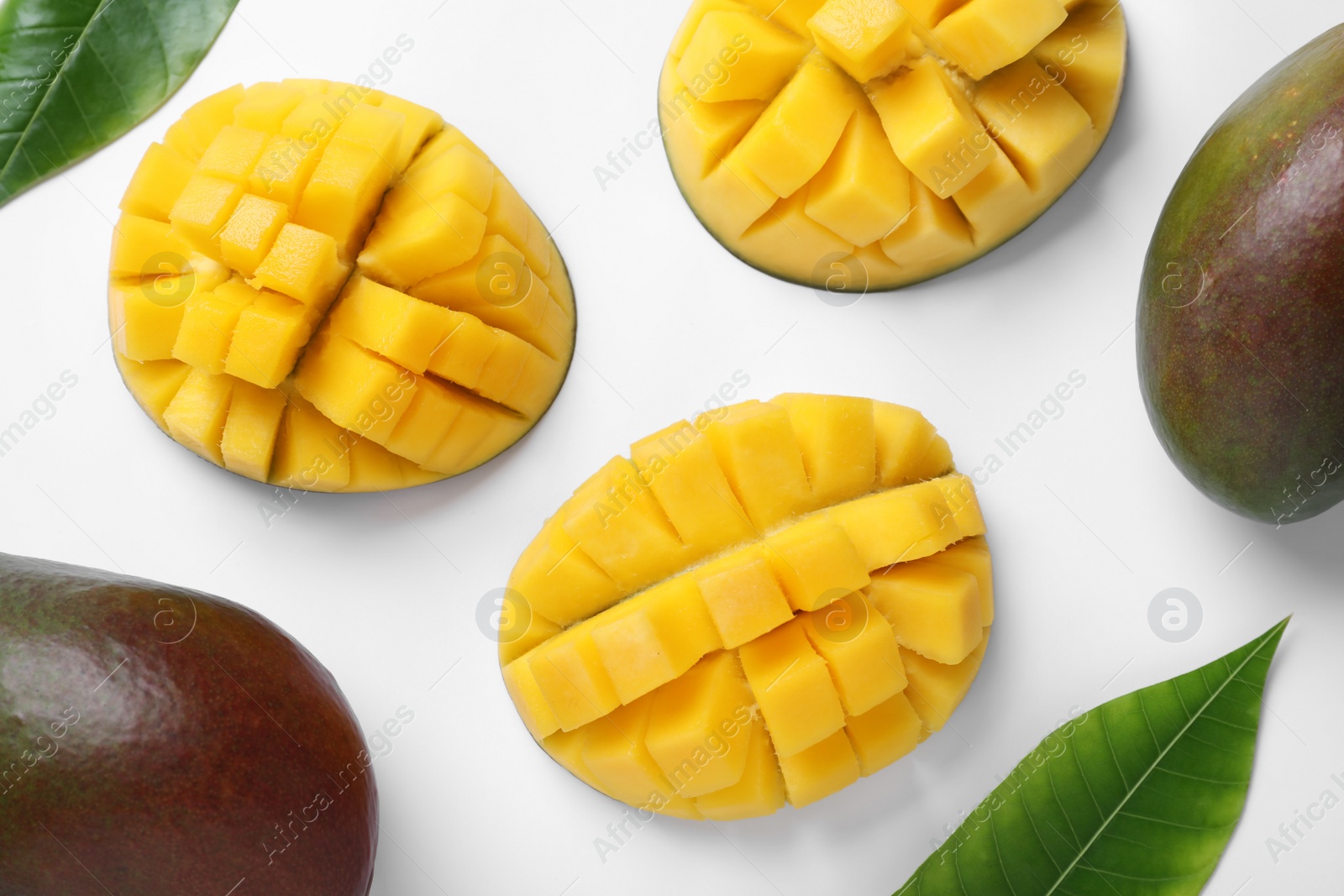 Photo of Ripe mangoes on white background, flat lay