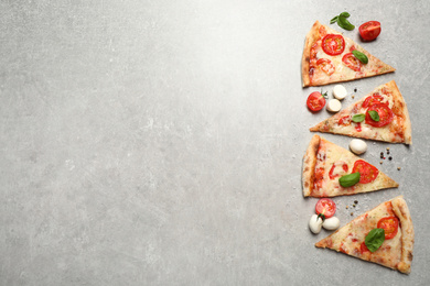 Slices of delicious pizza Margherita on light grey table, flat lay. Space for text