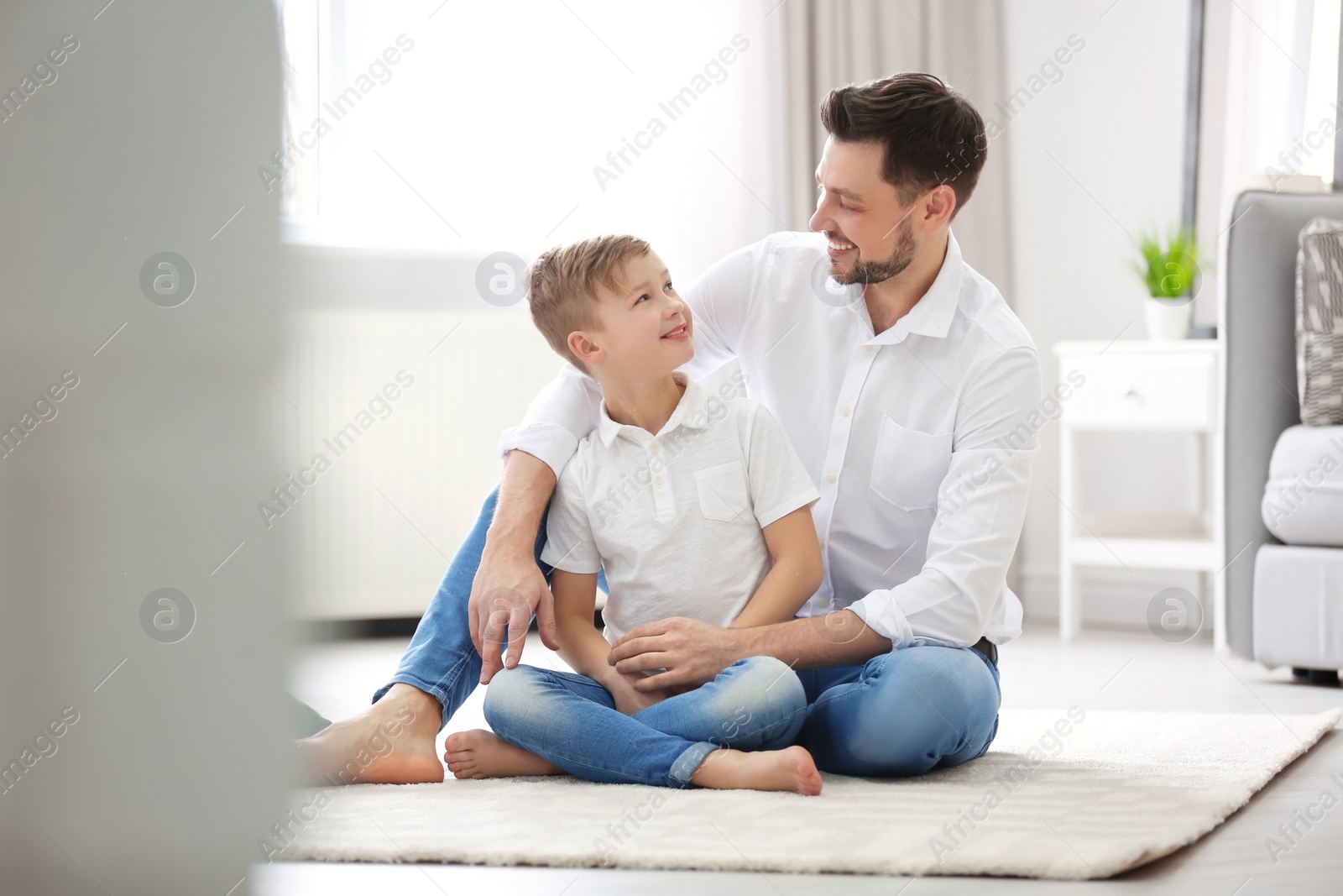 Photo of Little boy and his dad spending time together at home