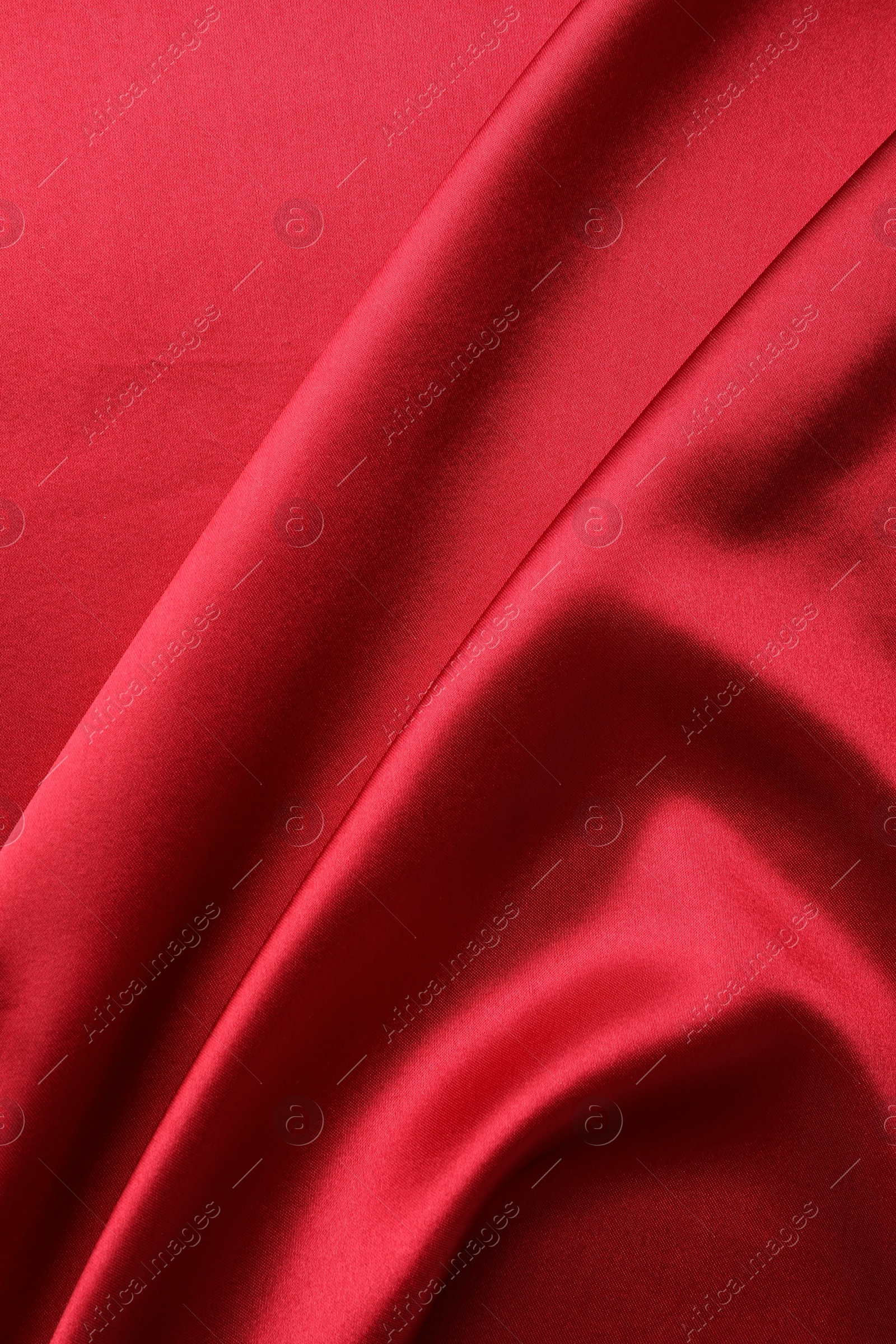 Photo of Texture of beautiful red silk fabric as background, closeup