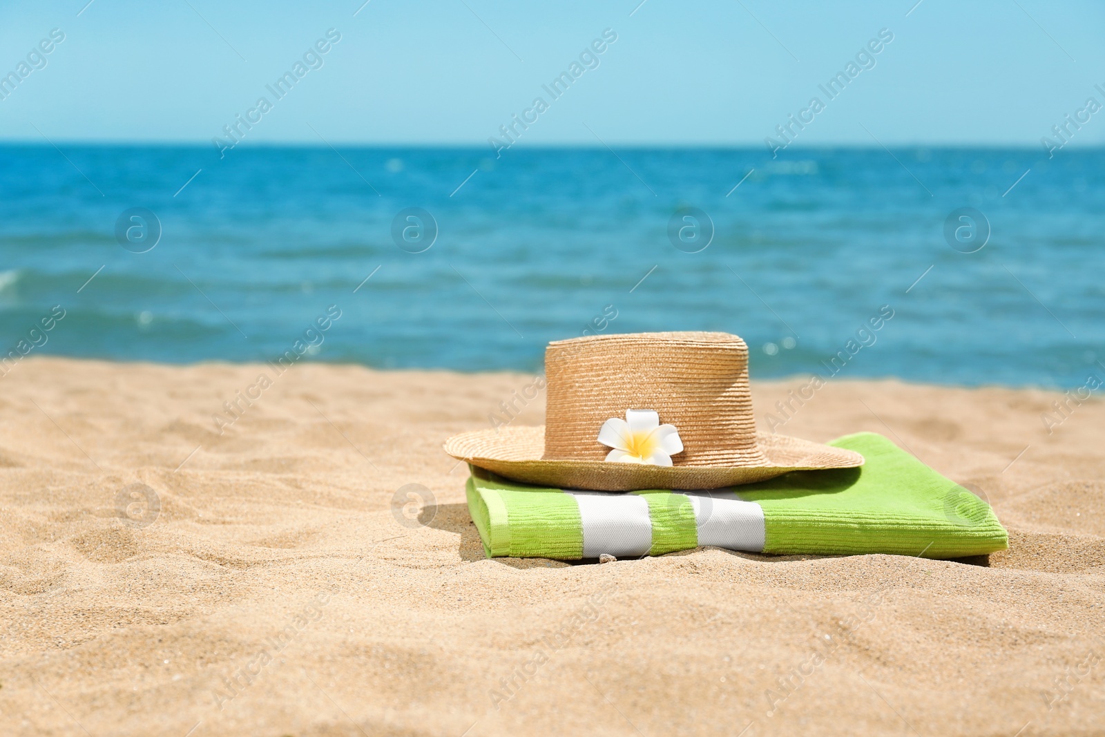 Photo of Different beach objects on sand near sea. Space for text