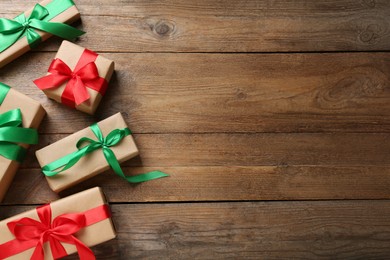 Photo of Many gift boxes on wooden table, flat lay. Space for text