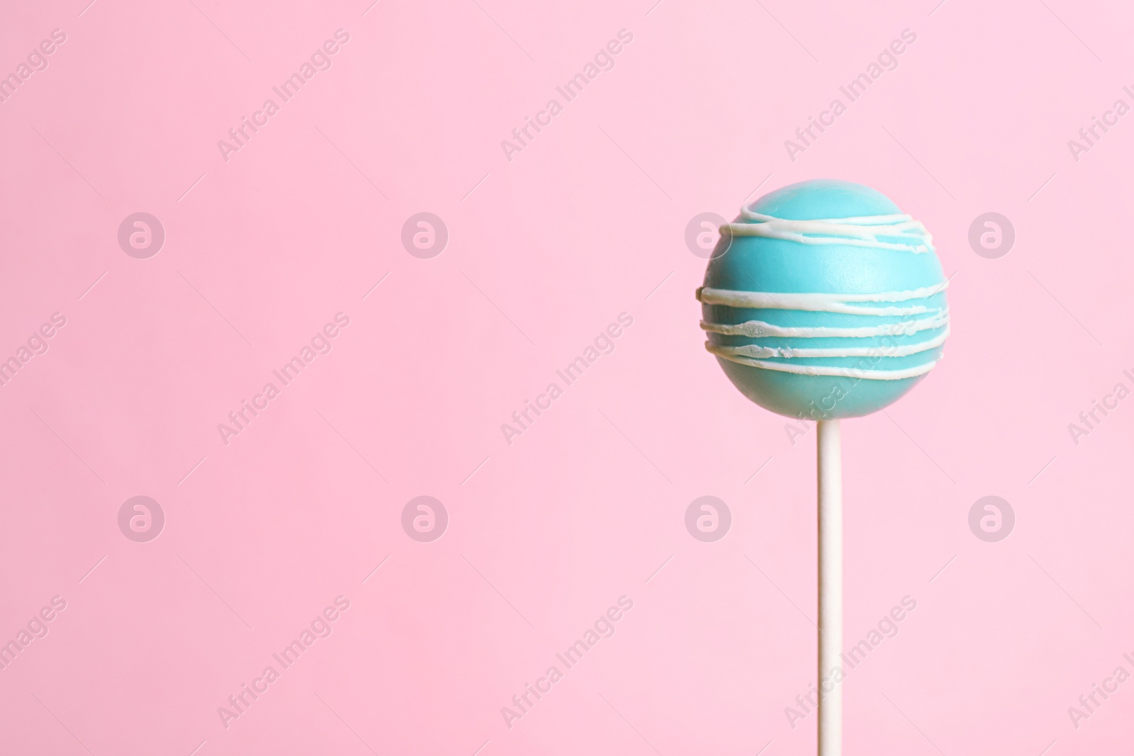 Photo of Bright delicious cake pop on color background. Space for text