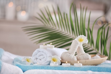 Photo of Supplies for massage on bed in modern spa salon. Place for relaxation