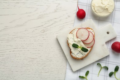 Photo of Toasted bread with cream cheese, radish and microgreen on white wooden table, flat lay. Space for text