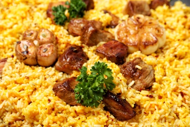 Photo of Delicious rice pilaf with meat as background, closeup