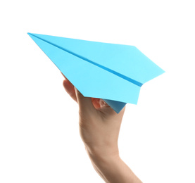 Woman holding light blue paper plane on white background, closeup