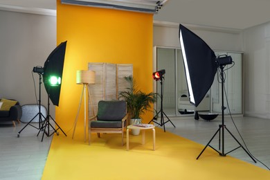 Stylish furniture in photo studio with professional equipment